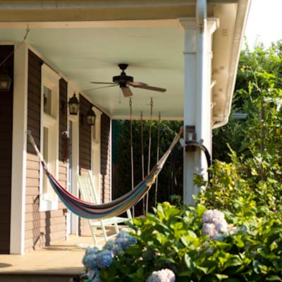 front porch with hammock and ceiling fan