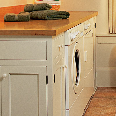 washer and dryer under laundry room countertop
