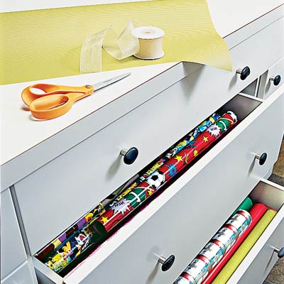 drawers containing gift wrap in family room laundry room
