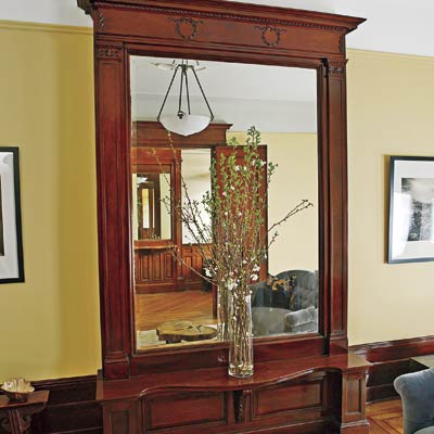 a living area that focuses on the ceiling-length pier mirror