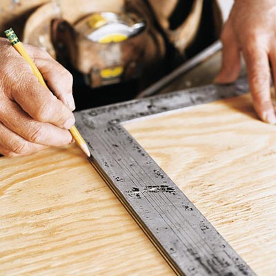man using a square to check for accuracy