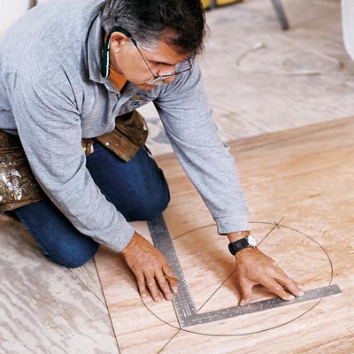 man using framing square to find center of circle