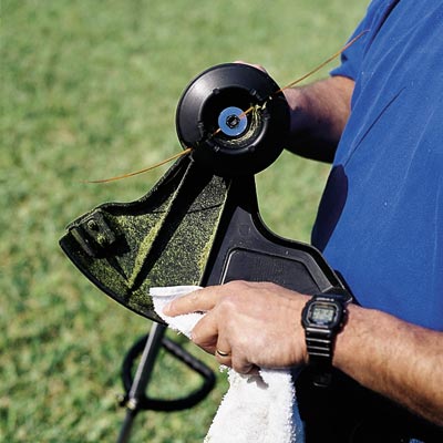 man cleaning string trimmer