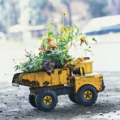 an old toy truck used as an outdoor planter