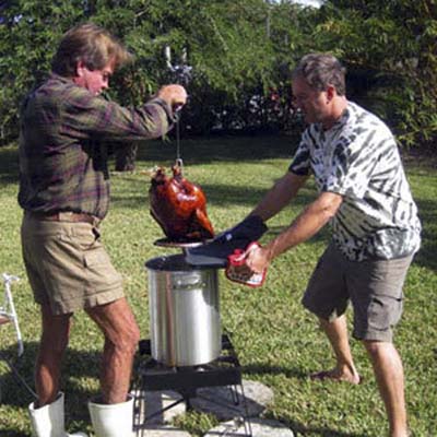two men using a turkey fryer