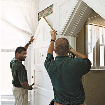 crew members removing accent door