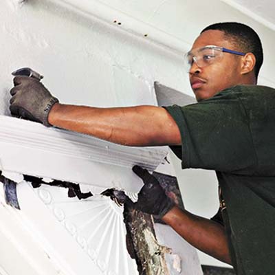 crew members removing accent door