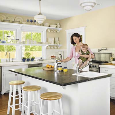 soapstone kitchen island, open cabinets, salvaged white tile countertops in sustainable home's kitchen