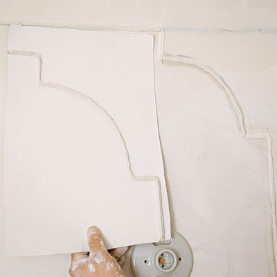 comparing new plaster detail to old during the toh tv los angeles house project remodel