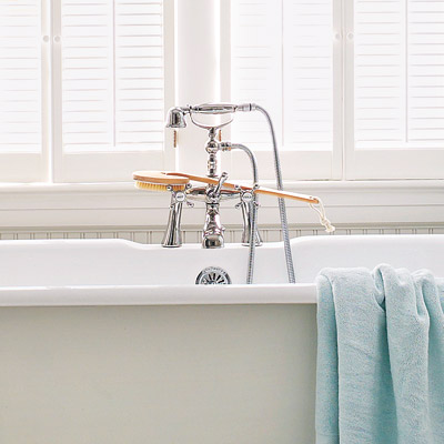 victorian bathroom with exposed tub pipes