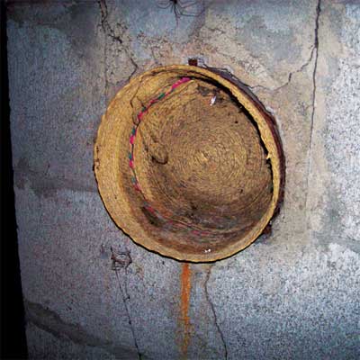straw hat used to cover hole in a chimney