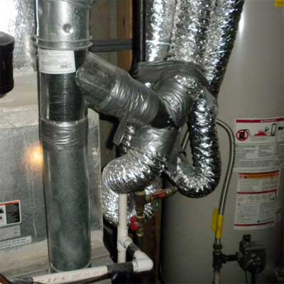 furnace flue connecting exhaust ducts from laundry, kitchen and bathroom