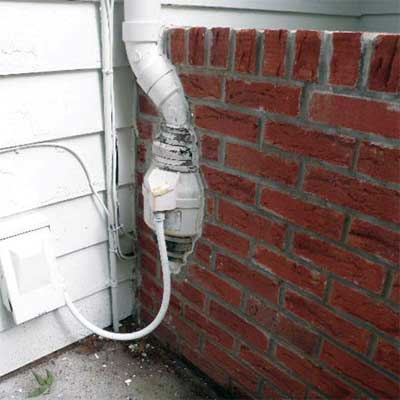 external fan built into a brick and mortar wall