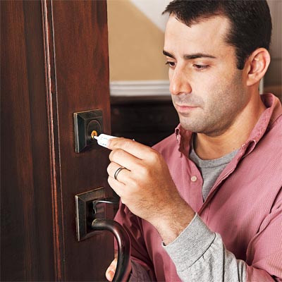 man fixing door lock