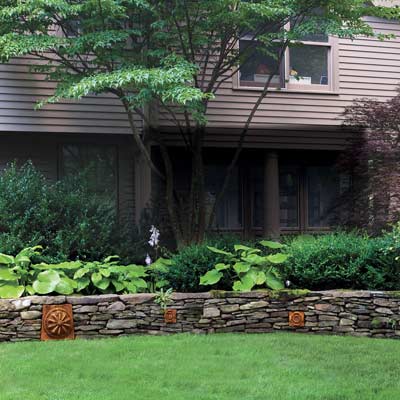 stone wall separating garden and lawn
