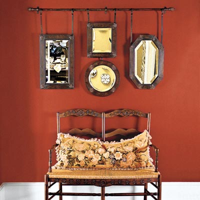 antique mirrors hung on a rod as wall art