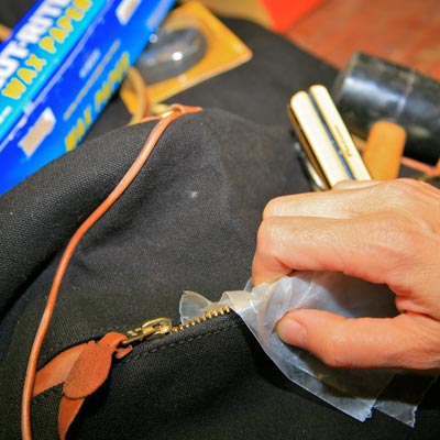 freeing a stuck tool bag zipper with wax paper