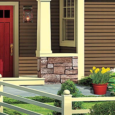 ranch house with stone half walls on porch