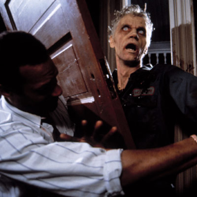 night of the living dead scene with zombie breaking through front door