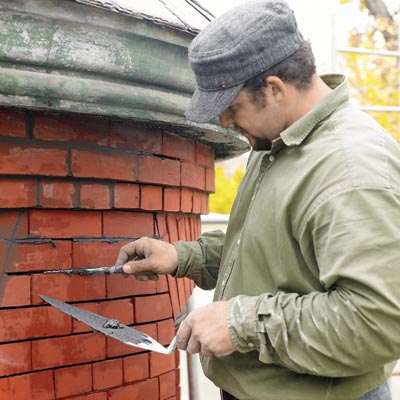 Chimney sweeper inspecting chimney