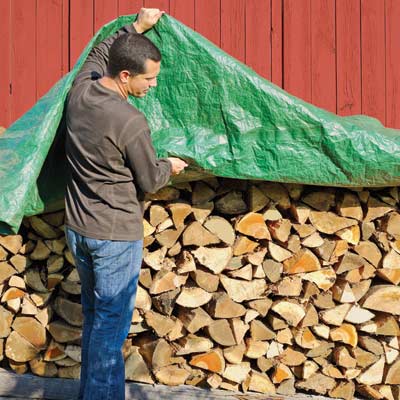 Fire wood under storage tarp