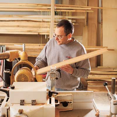 Homeowner shown in workshop cutting crown molding additions