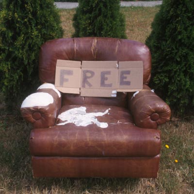 beaten up chair with free sign