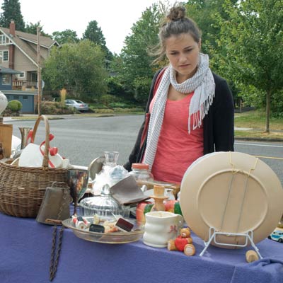woman looking at yard sale display table