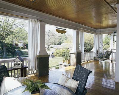 Porch with beadboard ceiling, thick columns and pine floors in an Atlanta Bungalow