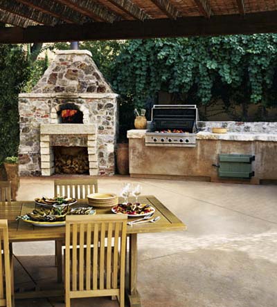 outdoor kitchen patio dining with wood-burning stove and grill top