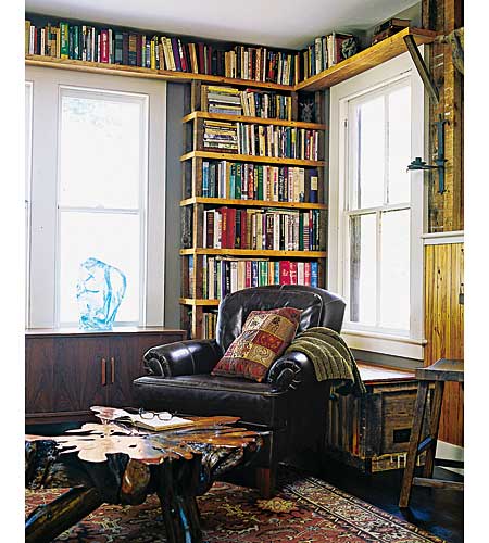 library with built in shelving and salvaged table
