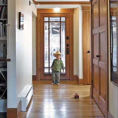 homeowners' son Devon plays on entry area floor made from recycled maple from an old linen mill