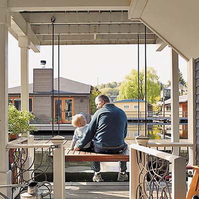 remodeled houseboat owner and his son sitting on their deck on Seattle's Lake Union