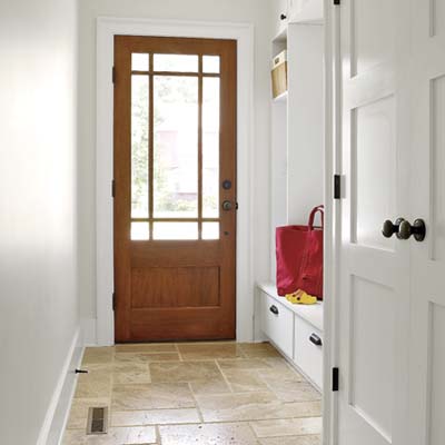 after photo of hallway redo as mudroom with built-ins and travertine floor at Cape Cod remodel