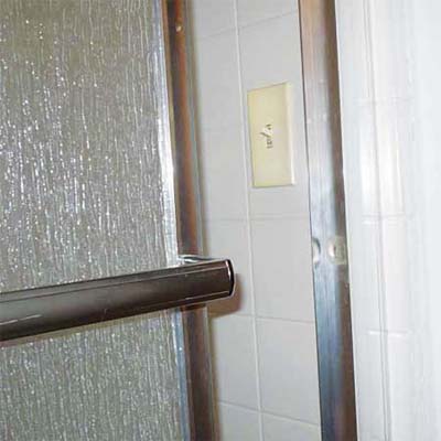 operational light switch hooked up inside a shower stall