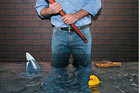 man standing in flooded basement