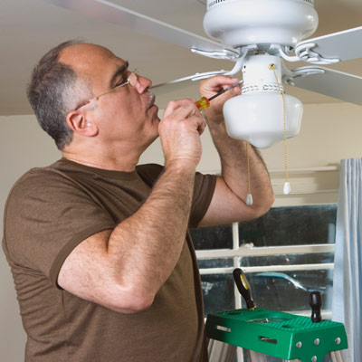 man installing a ceiling fan 