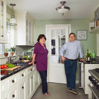 homeowners in white kitchen of colonial revival home