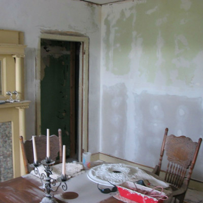 before image of 1879 parlor with paint stenciling to look like period wallpaper