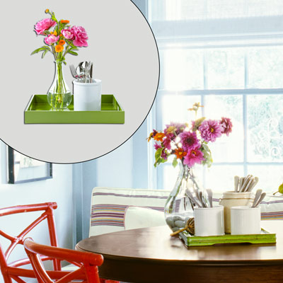 green serving tray, decanter-style vase with flowers and silverware holder