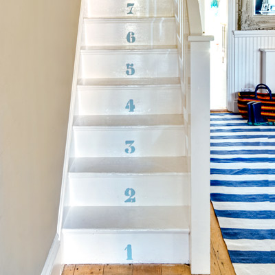 cottage style painted wood steps with numbers on risers 