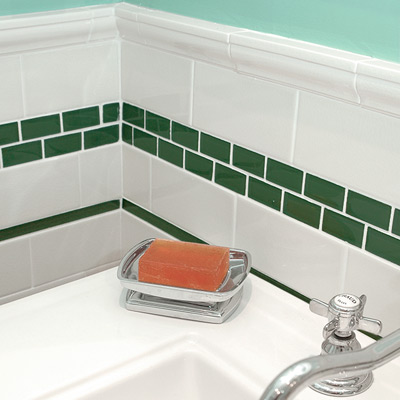 bath with green liner and white subway tiles, green mosaic tiles band 