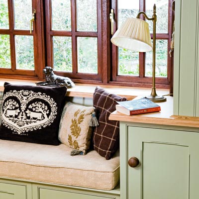 window seat with cushions and a lamp 