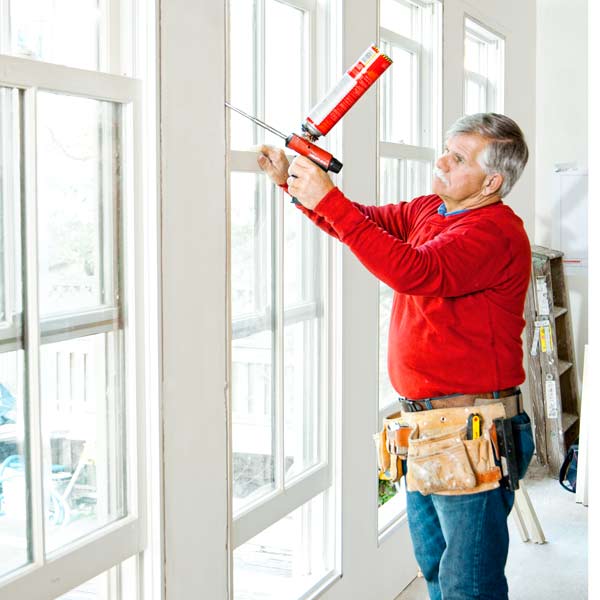 Tom Silva sealing air gaps in windows with canned spray foam