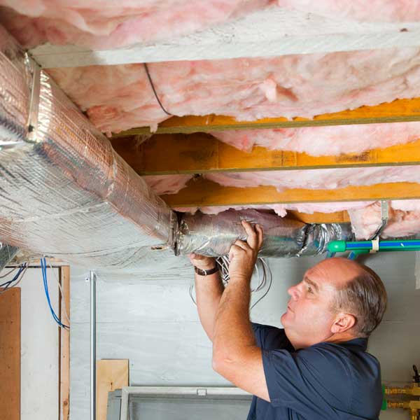 Richard Trethewey setting up HVAC system for slashing energy costs