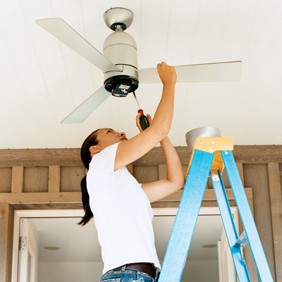 woman installing a ceiling fan 