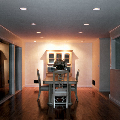 dining area with retrofit light fixtures that look like can lights 