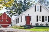 family gathered in kitchen of renovated farmhouse