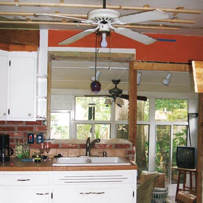 Kitchen with Marble Tile, Concrete Counters, Wood Cabinets and Butcher-Block Island