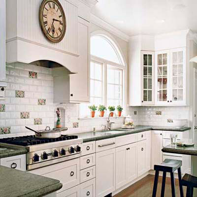 white kitchen with subway tiles and glass-fronted cabinets